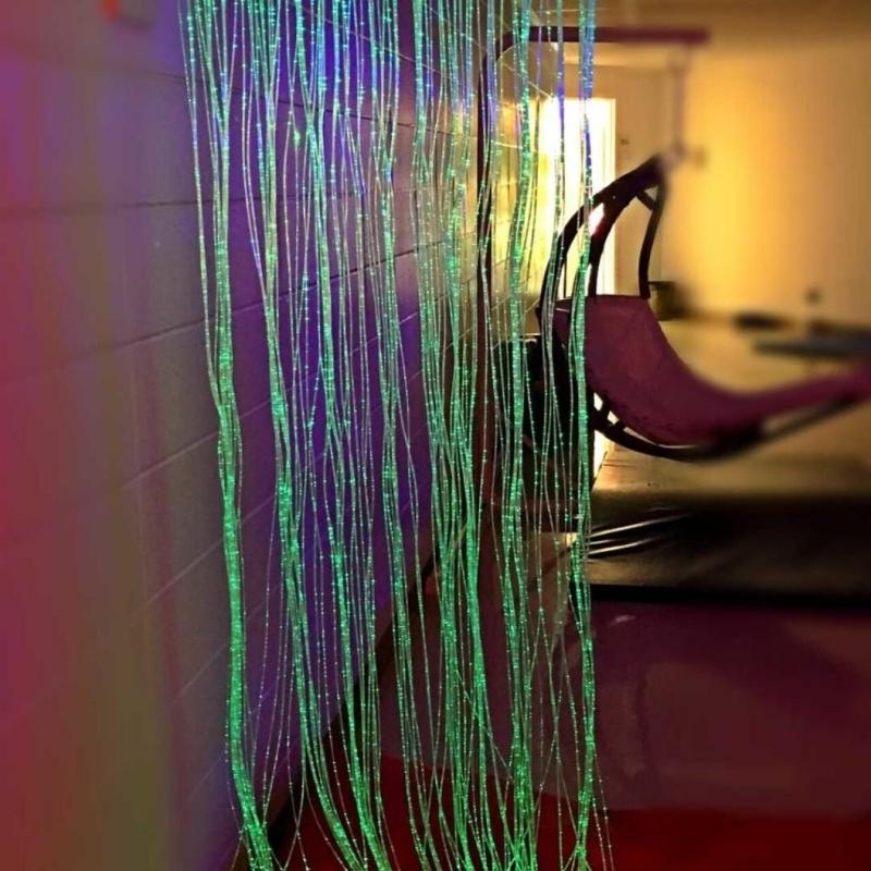 TFH Wall Mounted Fiber Optic Curtain in full landscape view showing the 100-strand curtain mounted on a wall, a calming sensory light for schools, therapy rooms, and home