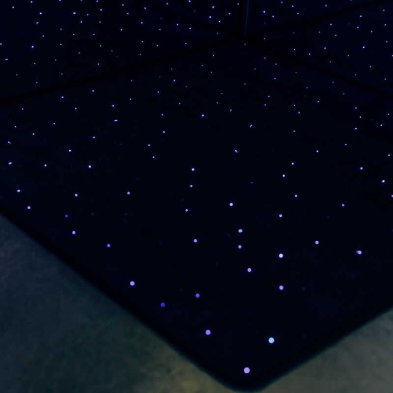 TFH Fibre Optic Carpet in a darkened sensory room showing the full star-field colour-changing effect of the Vorwerk carpet with PMMA fibre optic strands illuminated by the sparkle light source