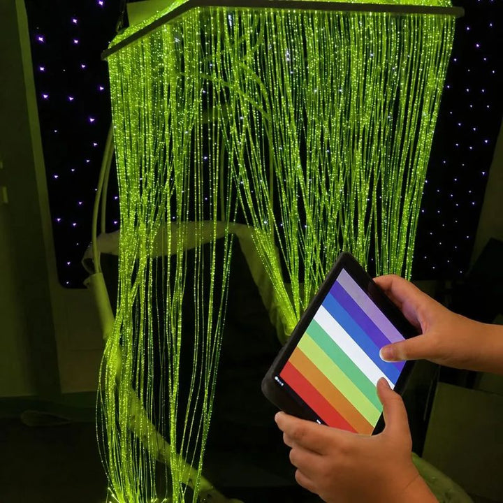 Hands choosing a colour on the MSE Genie App to turn the TFH Fibre Optic Waterfall Genie Controlled System green, giving users Bluetooth colour control