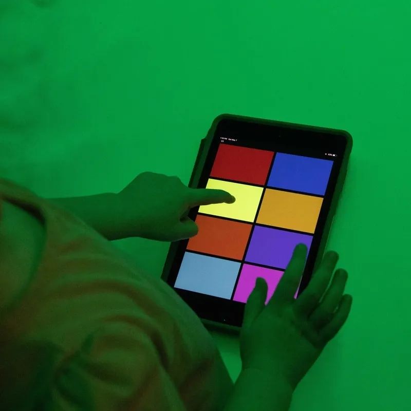 Close-up of a hand using the MSE Genie app colour control interface on a tablet with the TFH Genie Receiver