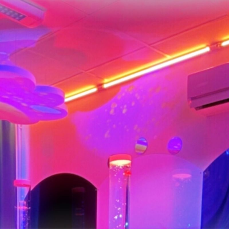 TFH Genie Colour Wash Kit in purple tones, creating a calming visual sensory environment in a therapy room or multi-sensory space