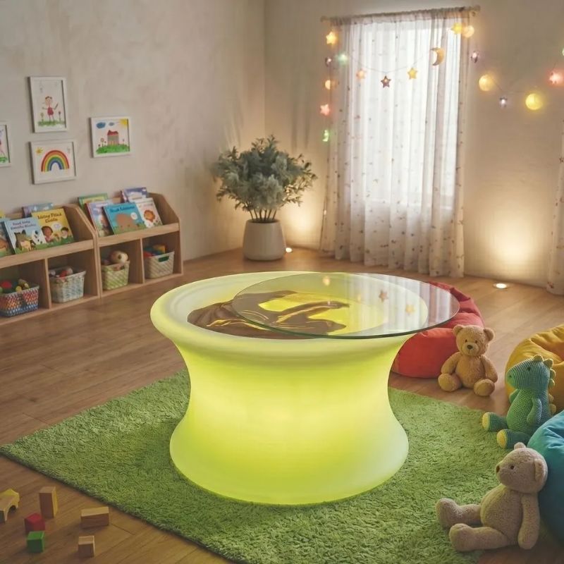 TFH Illuminated Sensory Messy Mood Table with its glass top slid open in a cozy playroom, an illuminated sensory table for hands-on exploration at home or school