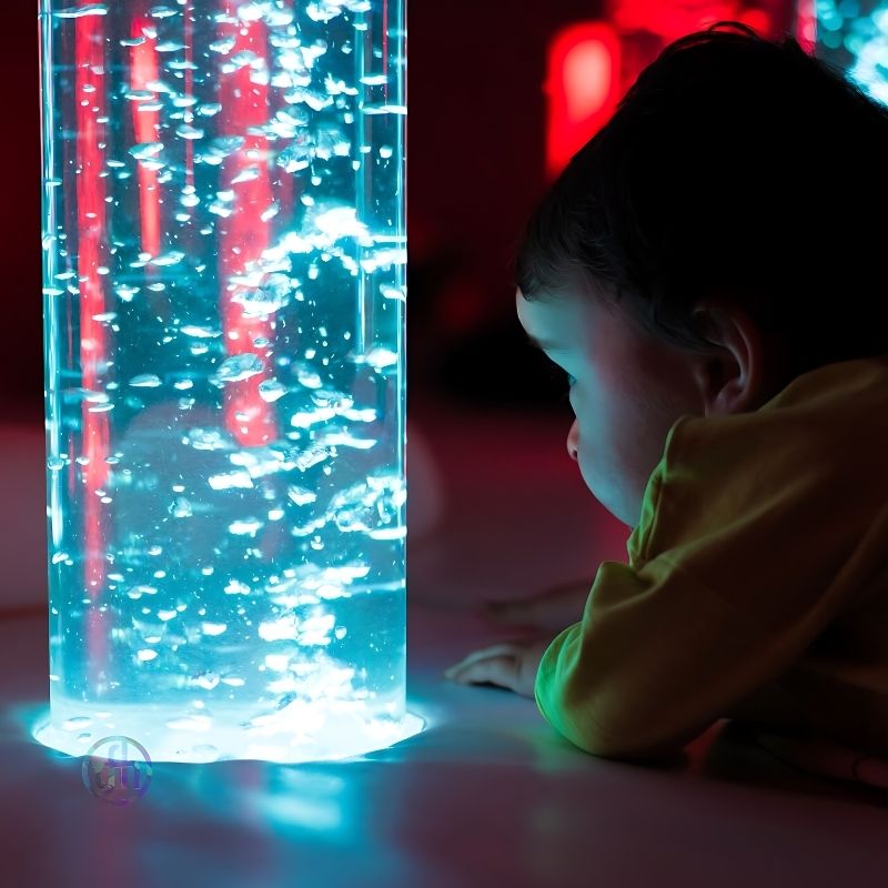 Baby exploring the TFH Interactive LED Bubble Tube, demonstrating safe tactile and visual sensory stimulation for infants