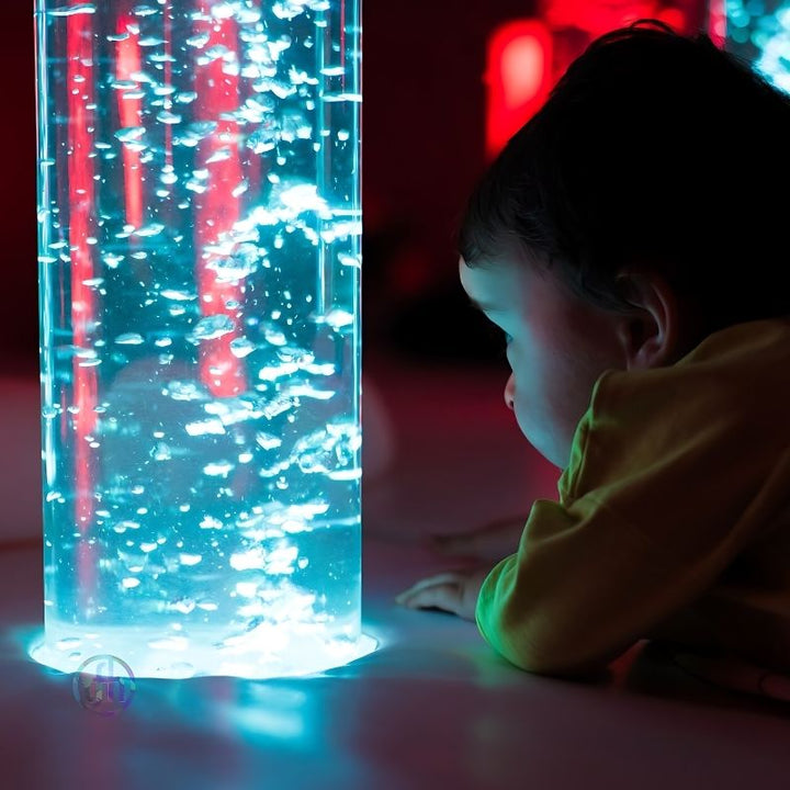 Baby exploring the TFH Interactive LED Bubble Tube, demonstrating safe tactile and visual sensory stimulation for infants