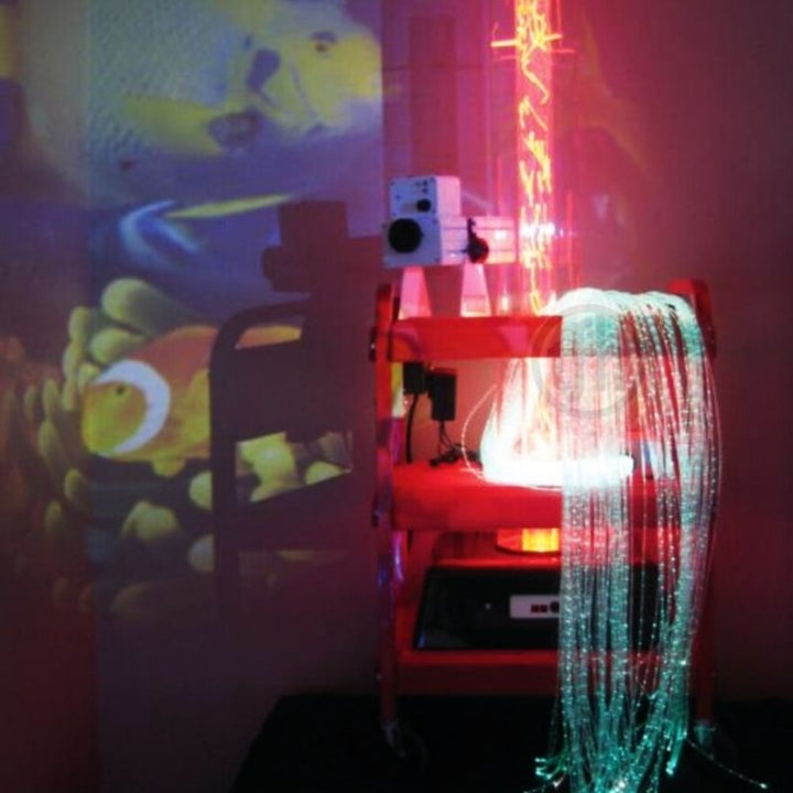 TFH Little Red Sensory Cart Deluxe Hurricane Waterless in a clinical or therapy room setting showing the portable waterless sensory station projecting onto a wall with fibre optic tails in use