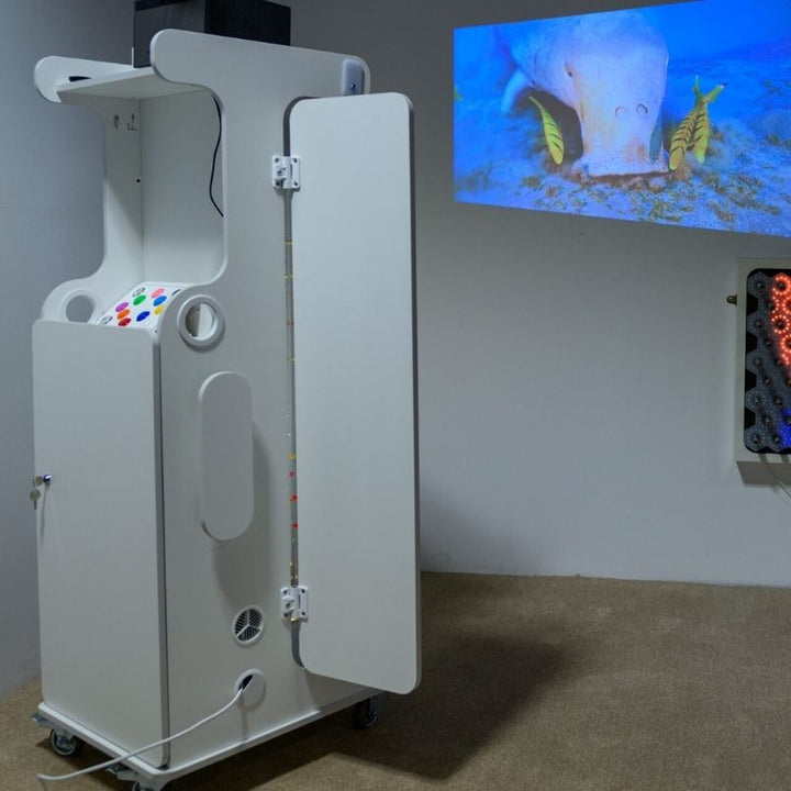 Side view of the TFH Mobile Sensory Cart Deluxe showing marine MDF construction, acrylic mirror wing, locking caster wheels, and full cart profile