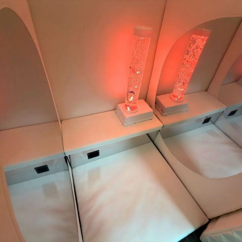 Inside the TFH Deluxe Portable Sensory Den, the orange-lit bubble tube on its box seat reflected in the acrylic mirror above the padded floor