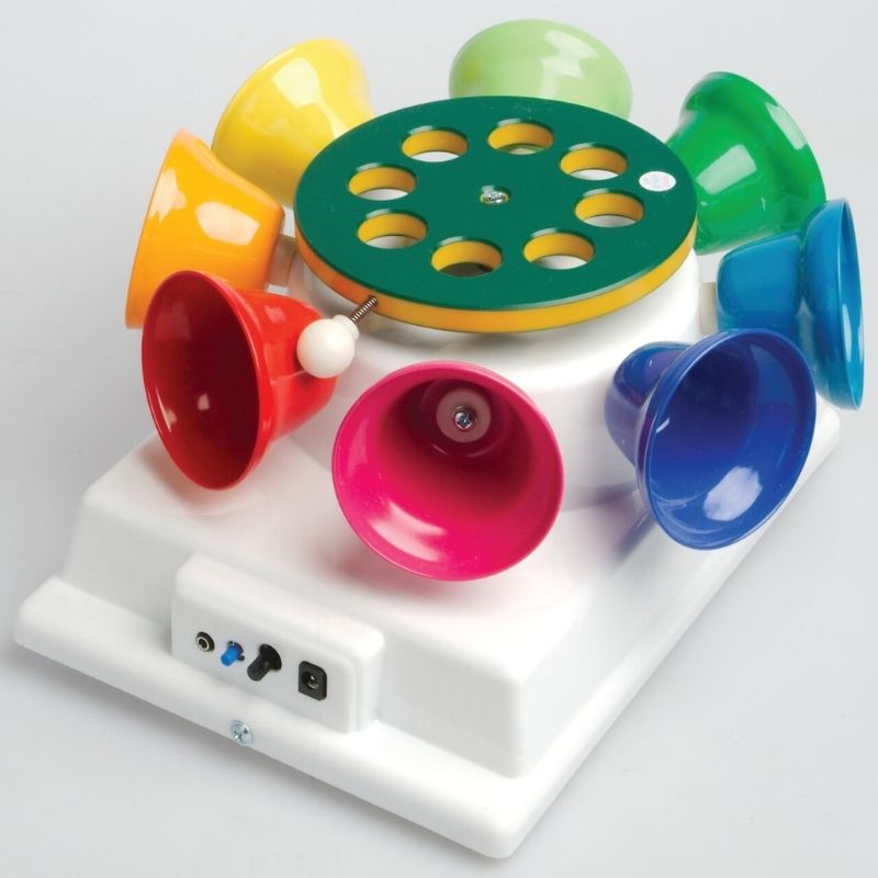 Child or adult using the mallet to play the TFH Rainbow Carousel Bells, demonstrating independent musical play and auditory sensory exploration