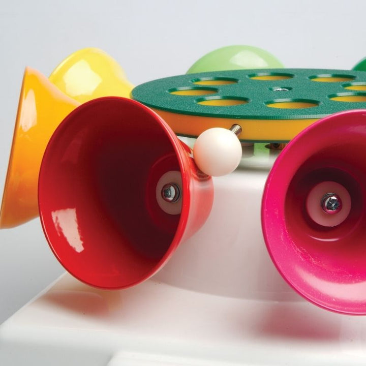 Close-up of the TFH Rainbow Carousel Bells showing precision-tuned bells and weighted ball striker mechanism for clear auditory tone production