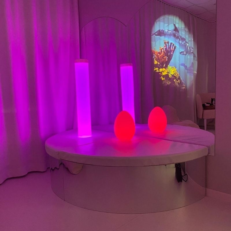 TFH Bubble Tube Corner Seat Base corner installation in pink ambient sensory room lighting