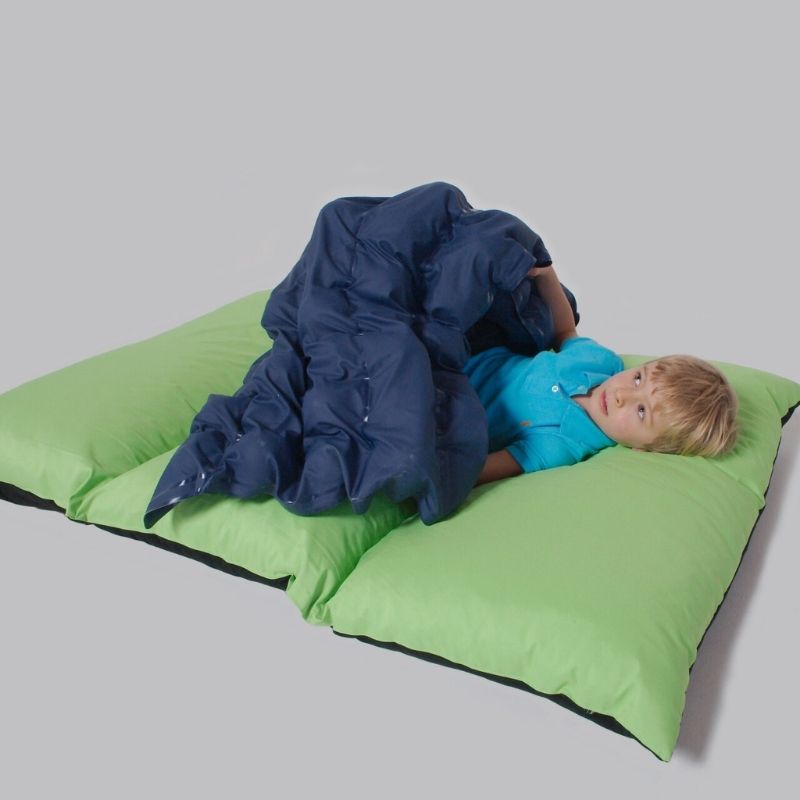 Child lying on the TFH Sensory Pressure Vinyl Ball Pad, showing the full 55" x 32" seam-free hospital-grade vinyl surface delivering deep pressure input