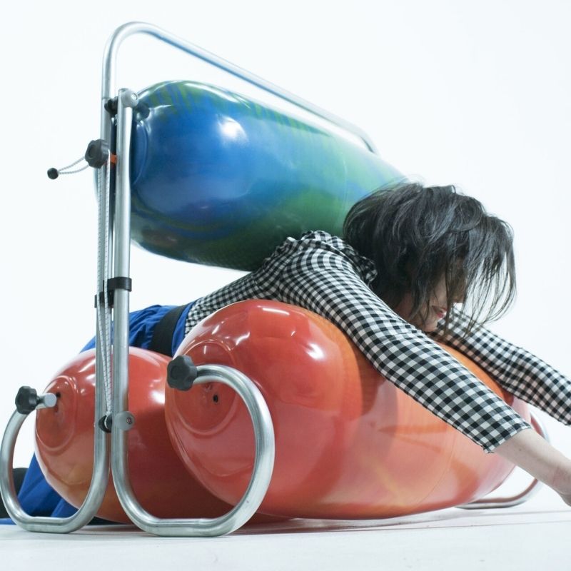 Adult using the TFH Squeeze Machine, showing the adjustable deep pressure sensory tool accommodates children and adults of all ages for proprioceptive regulation
