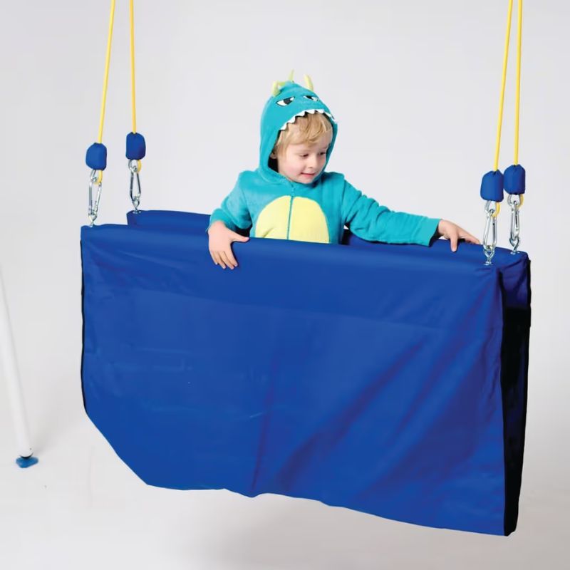 Toddler seated inside the TFH Deluxe Taco Swing, a snug proprioceptive sensory swing offering deep pressure and vestibular comfort