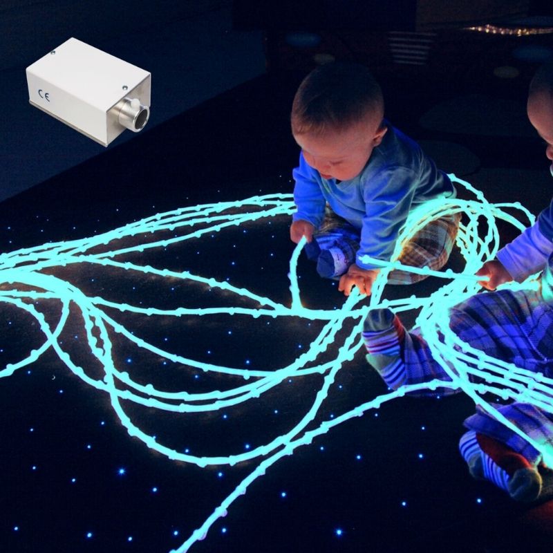 TFH Textured Light Spray top view with a child actively playing with the 12 knotted bamboo-effect fibre optic tails, demonstrating the tactile and visual sensory experience of the colour-changing textured fibre optic spray