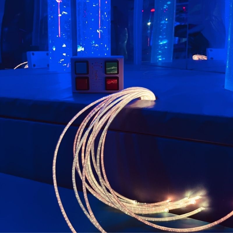 TFH Thick Fibre Optic Tails with light source showing extra-thick colour-changing polymer strands for visual and tactile sensory stimulation in sensory rooms and therapy spaces