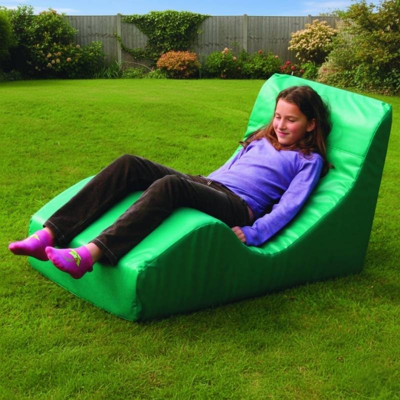 TFH Vibroacoustic Contour Relaxer in use with a child in a relaxed outdoor setting, demonstrating the full-body low-frequency vibration therapy chair for sensory rooms and home use