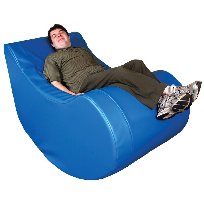 TFH Vibroacoustic Therapy Rocker in use with an adult user against a clean background, showing the full-body vinyl-covered foam rocking chair for vibroacoustic and vestibular sensory therapy