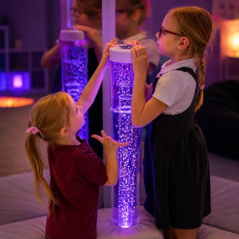 Two children placing their hands over the top grill of the TFH Interactive Waterless Hurricane Tube to change the swirling snow beads, hands-on cause-and-effect play