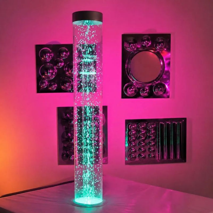 TFH Interactive Waterless Hurricane Tube glowing teal in front of mirrored sensory wall panels, a 6" colour-changing snow bead column for multi-sensory rooms