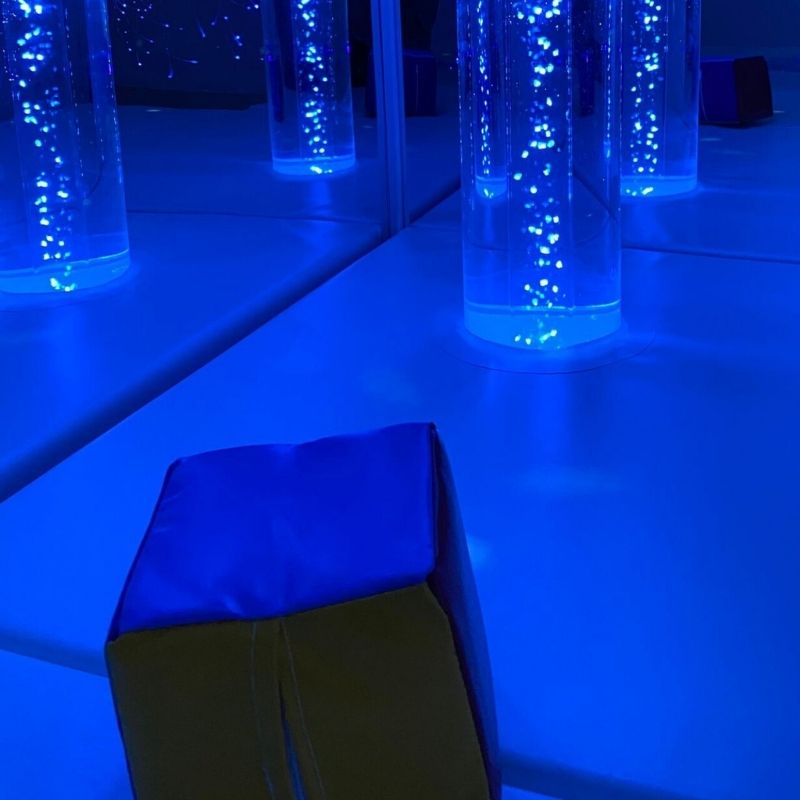 TFH Wireless Colour Controller Cube in a sensory room with blue LED colour selected, showing the wireless Genie receiver-powered colour change in a TFH bubble tube