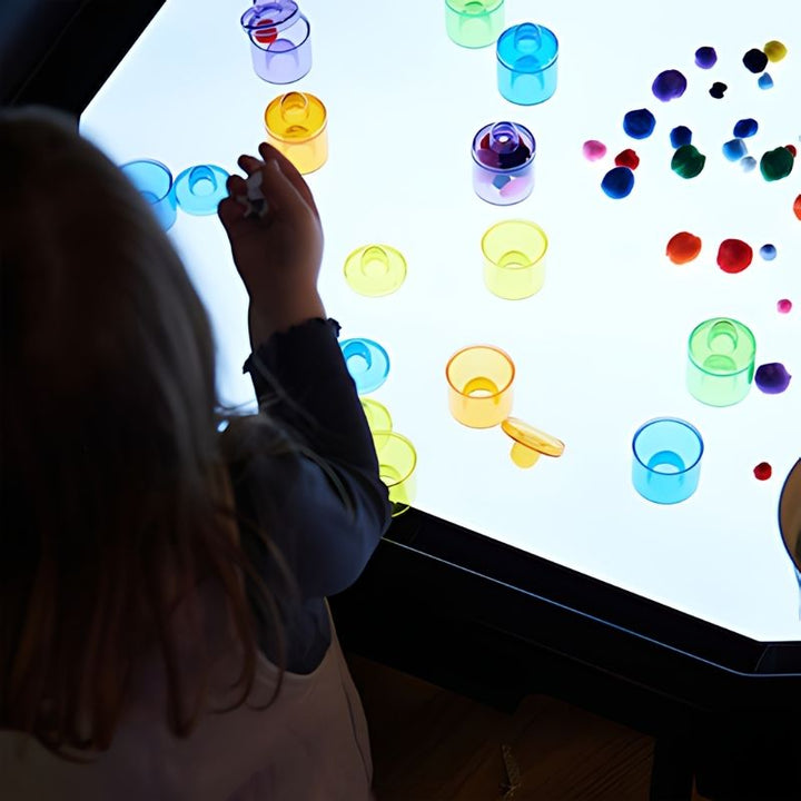 Top view of a child actively playing and learning with the TTS Active World Tray Light Panel sensory light surface
