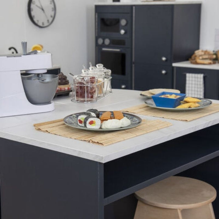 Top view of the TTS Breakfast Bar Island styled with play food and plated meals, showing the marble effect worktop surface for imaginative play