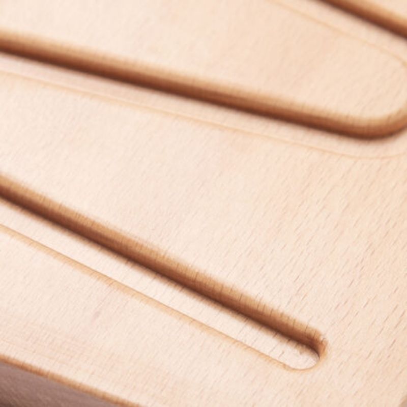 TTS Breathing and Mindfulness Board with small ball placed in engraved groove, demonstrating the alternative ball-rolling method for guided breathing practice