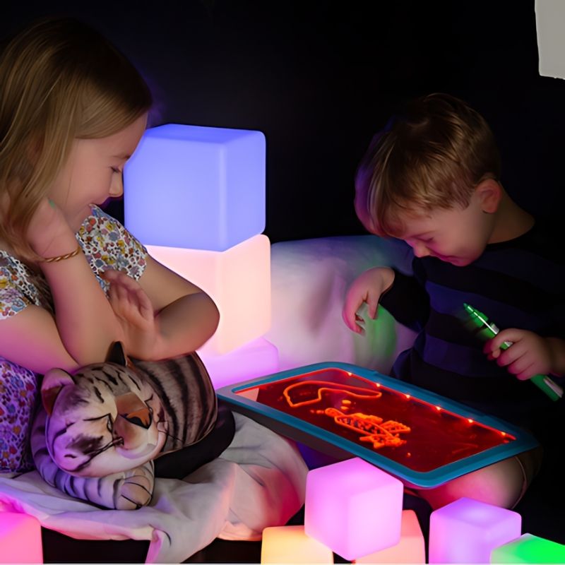 TTS Glow Construction Blocks and Sensory Illuminated Writing Board from the Calming Sensory Pod Starter Collection, supporting creative exploration, fine motor development and cognitive engagement within a sensory retreat space