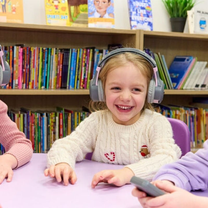 Six TTS ClassCast rechargeable headsets arranged for classroom use, each offering 8 hours of battery life for group listening and oracy activities