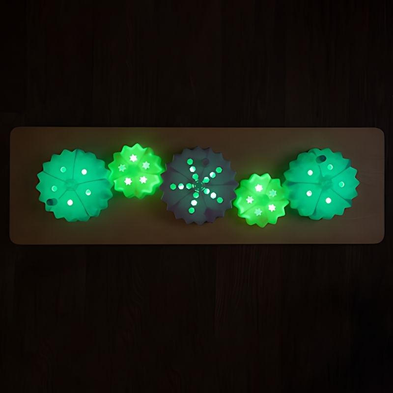 TTS Light Up Cog Board wall-mounted showing green colour-changing cog lighting, an interactive fine motor sensory resource