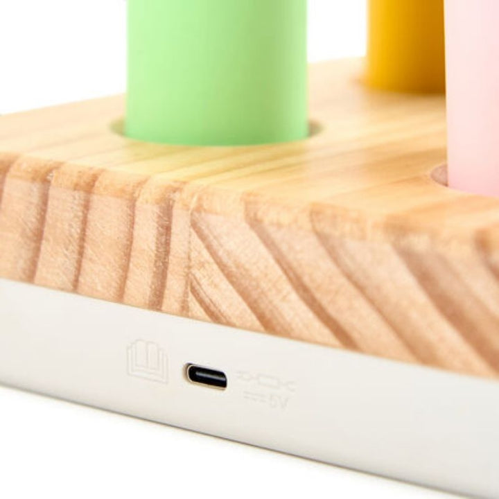 Close-up of the TTS Colour Changing Easi-Torch charging port, showing the built-in rechargeable connection that eliminates the need for disposable batteries