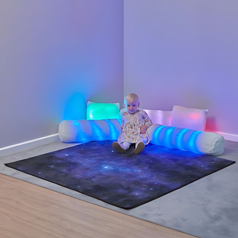 TTS Rechargeable Fibre Optic Sparkle Rug 100cm with a baby sitting on the touch-activated sensory light surface glowing in blue, ideal for sensory rooms and early years play