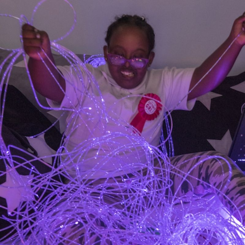 TTS Fibre Optic Tails glowing in purple, demonstrating the colour-changing sensory light effect during tactile play