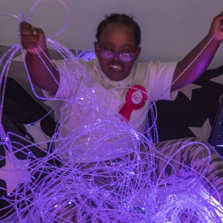 TTS Fibre Optic Tails glowing in purple, demonstrating the colour-changing sensory light effect during tactile play