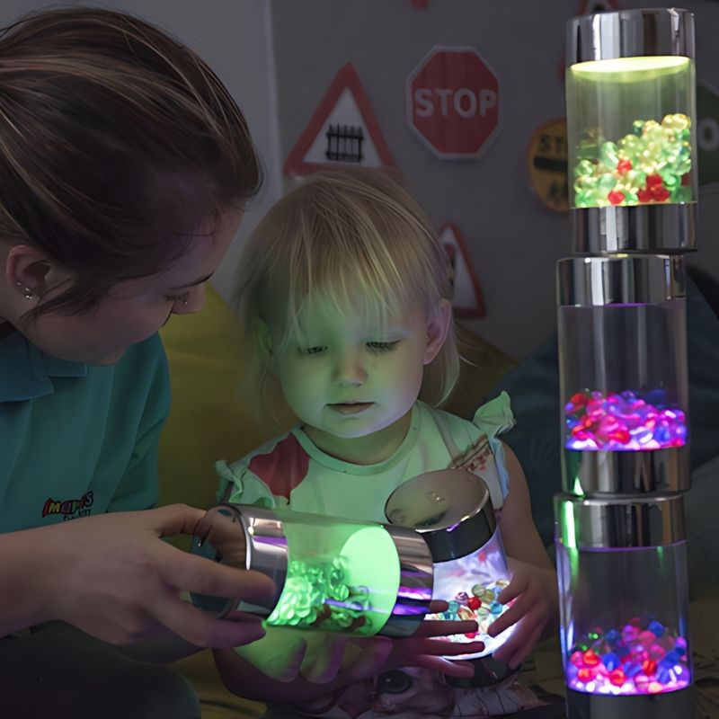 Parent and child exploring TTS Illuminated Glow Roller Shakers together, demonstrating sensory light play and cause-and-effect engagement