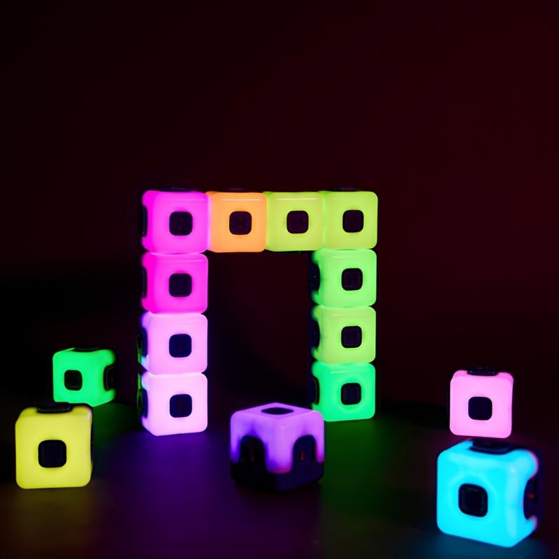 TTS Glow Sequencing Cubes arranged in a glowing square frame pattern against a dark background, showing magnetic connection and multi-colour sequencing in pink, green, purple, blue and yellow