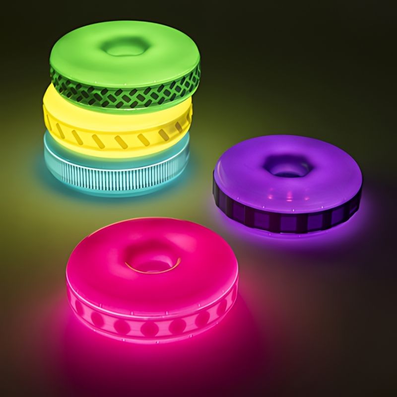 TTS Glow Stacking Discs arranged in a stacking configuration, illustrating the constructive and schematic play supported by this light-up sensory toy