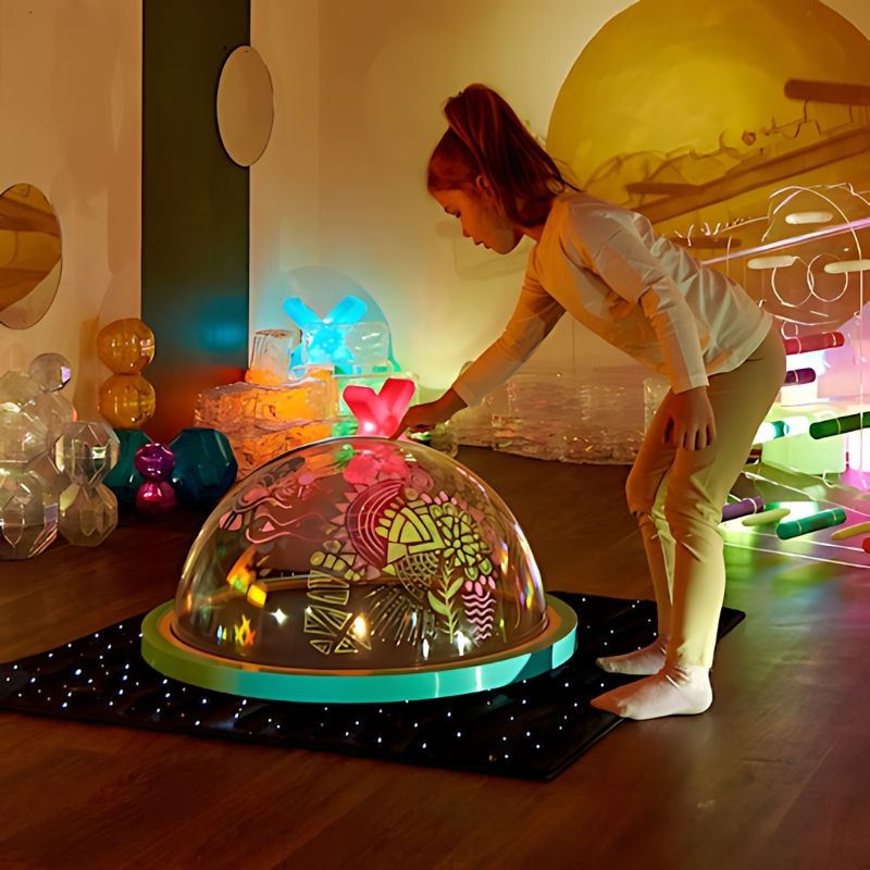 TTS Immersive Projector light dome with child standing during active sensory play, projecting light and shadow onto surrounding walls