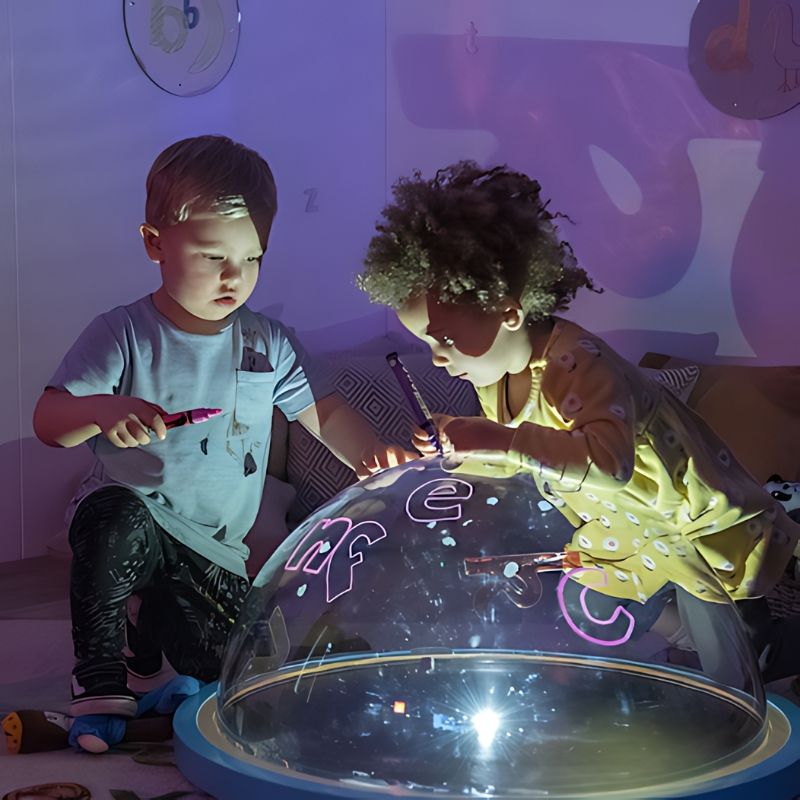 TTS Immersive Projector sensory light dome used for collaborative play, two children exploring light and shadow effects together