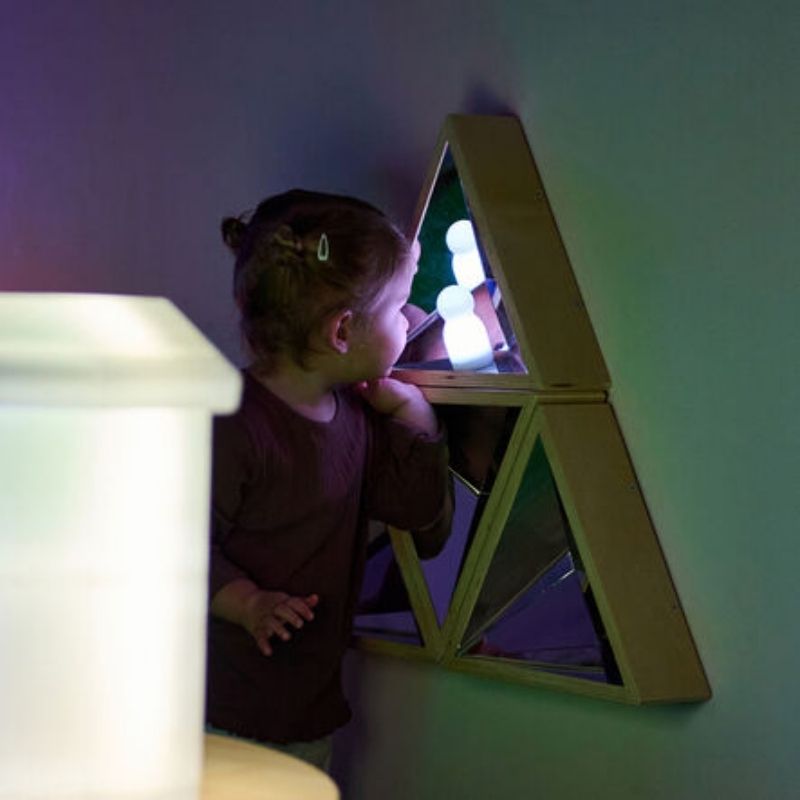 Child standing in front of the TTS Kaleidoscope Mirror, supporting self-awareness and communication development through sensory mirror play