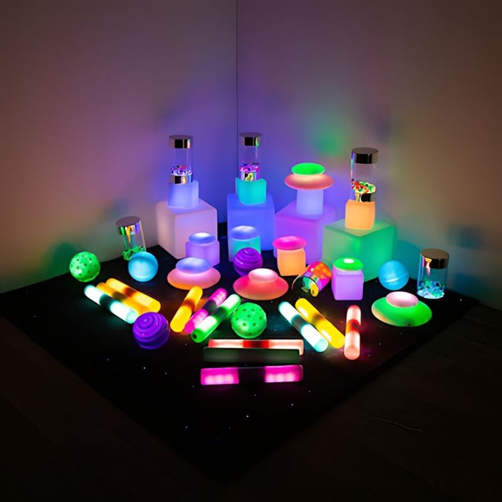 TTS Sensory Light Up Glow Collection arranged in a corner display, showing the full 48-piece LED kit set up as a sensory room light-play environment