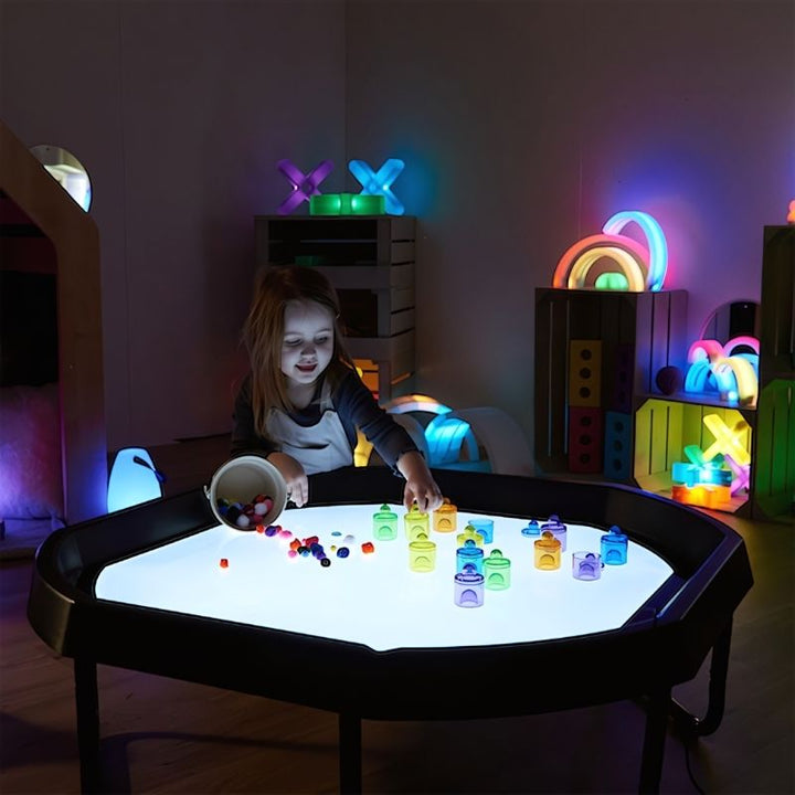 Child using the TTS Active World Tray Light Panel for hands-on sensory and visual exploration in an indoor play setting