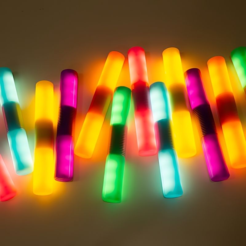 TTS Light Up Glow Cylinders displayed in all six colours, a rechargeable LED sensory toy set for early years learning and exploration