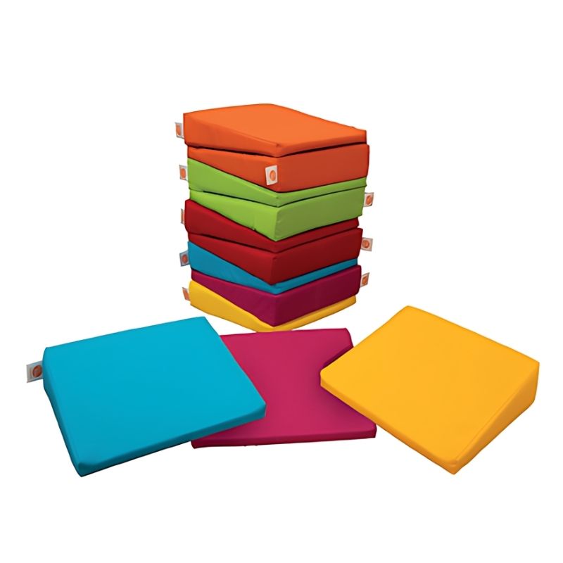 TTS Maxi Wedge 12 Pack arranged on a clean surface, ergonomic foam wedge cushions for classroom and sensory room seating