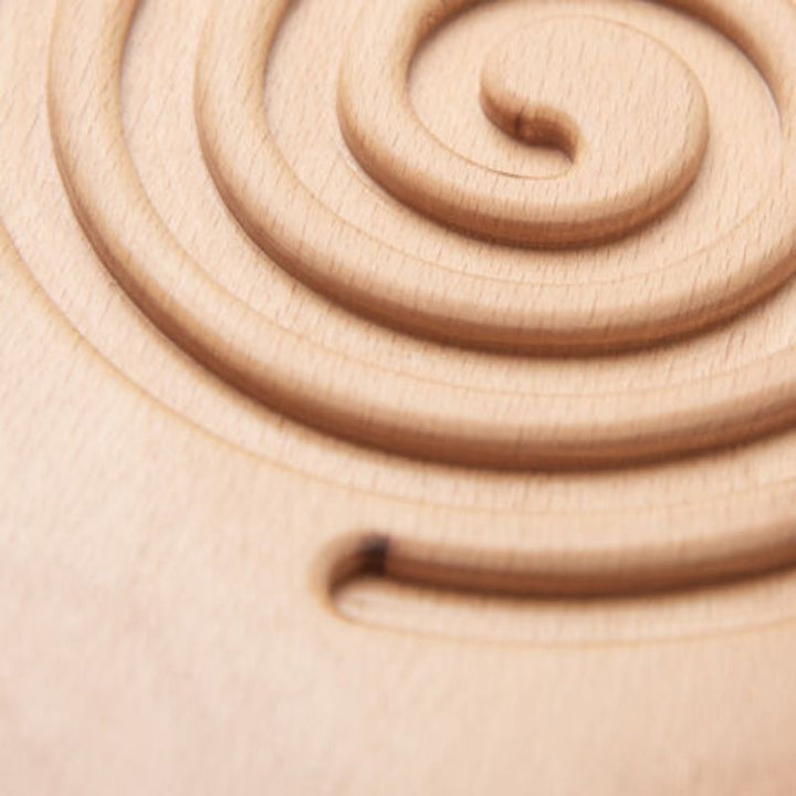 Close-up of a child's hands holding TTS Breathing and Mindfulness Board, illustrating the small-hand-friendly size of the portable beech wood sensory tool