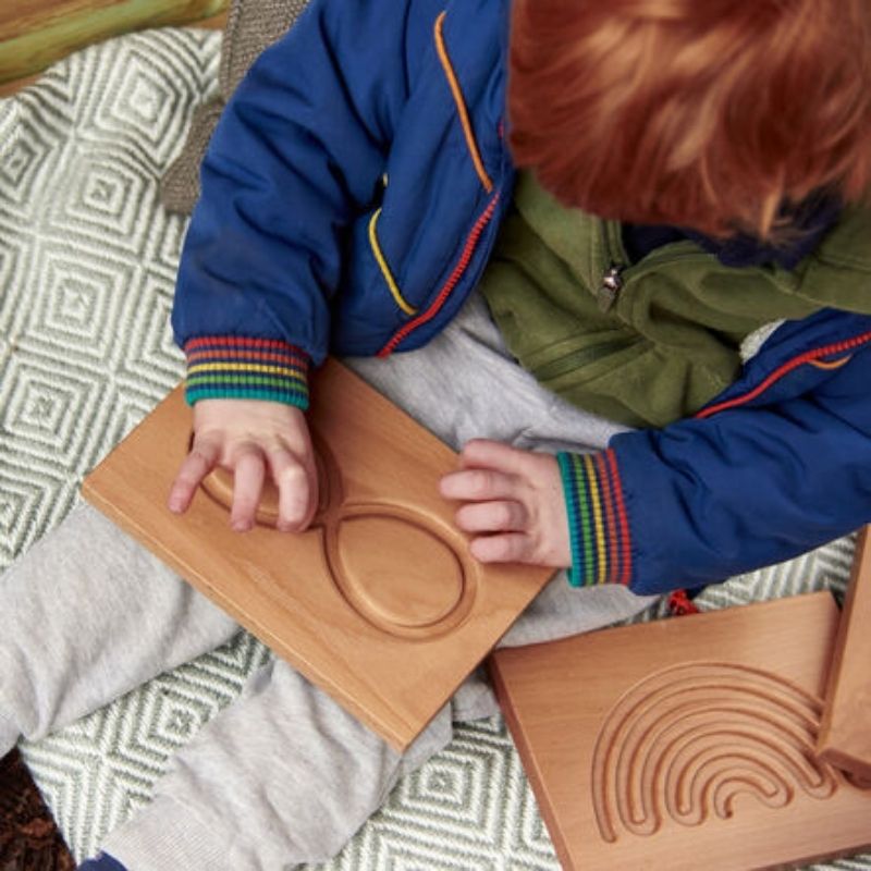 All six TTS engraved beech wood mindfulness breathing board designs laid out, showing the variety of finger-trace patterns for self-regulation practice