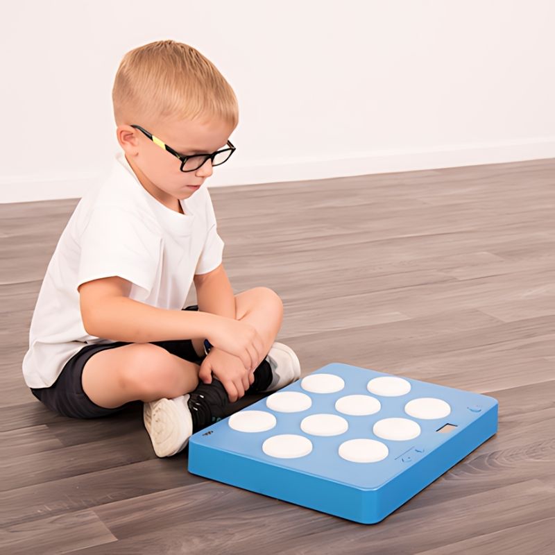 TTS Portable Light Up Reaction Wall Game set up as a classroom activity station, ideal for brain breaks, motor skills development, and inclusive active play for children of all ages and abilities