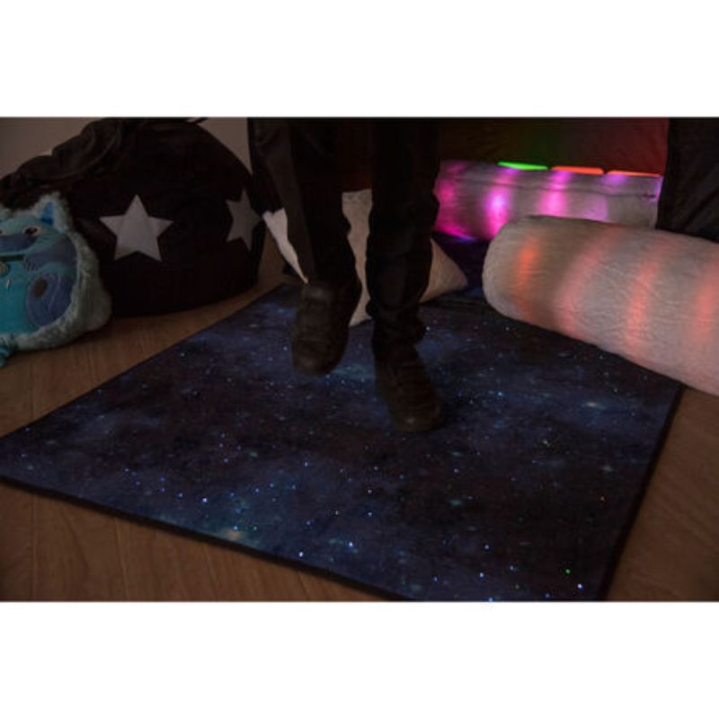 Child jumping onto the TTS Rechargeable Fibre Optic Sparkle Rug 100cm, its twinkling fibre optic stars adding visual sparkle to active sensory play