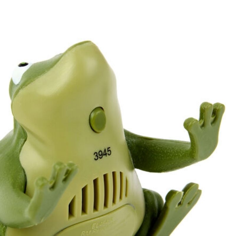 Underside view of a TTS Recordable Talking Frog showing the button and battery compartment for the recordable communication toy