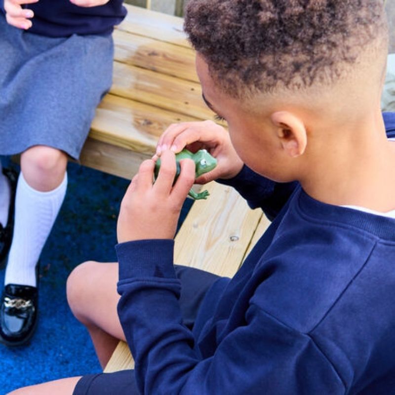 Child engaging in active play with TTS Recordable Talking Frogs, using them for hands-on speech and communication learning